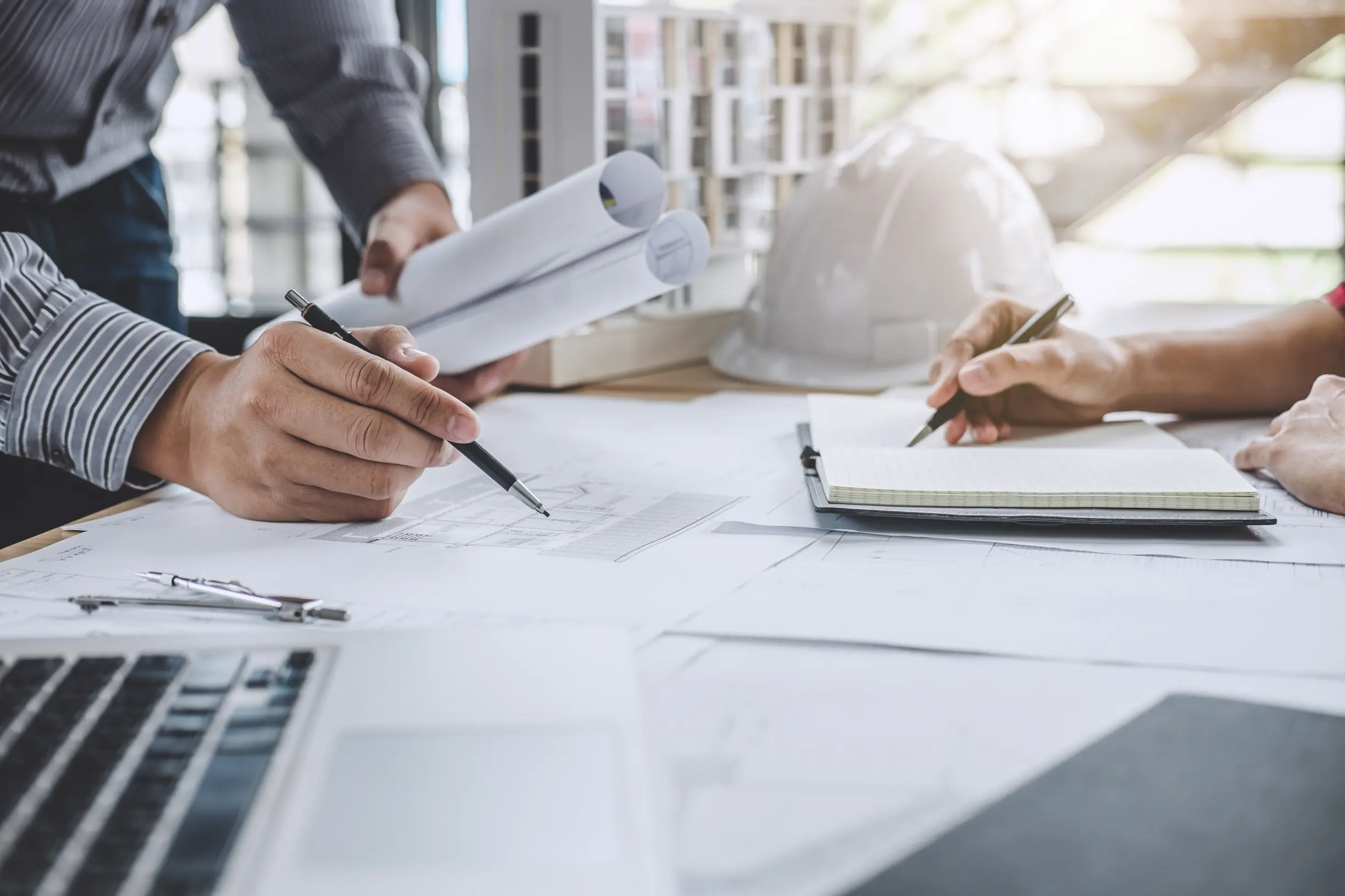 Engineers reviewing commercial solar project drawings and construction documents.