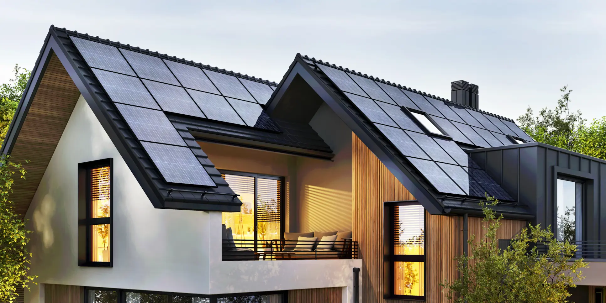 Modern two-story home with rooftop solar panels at sunset.