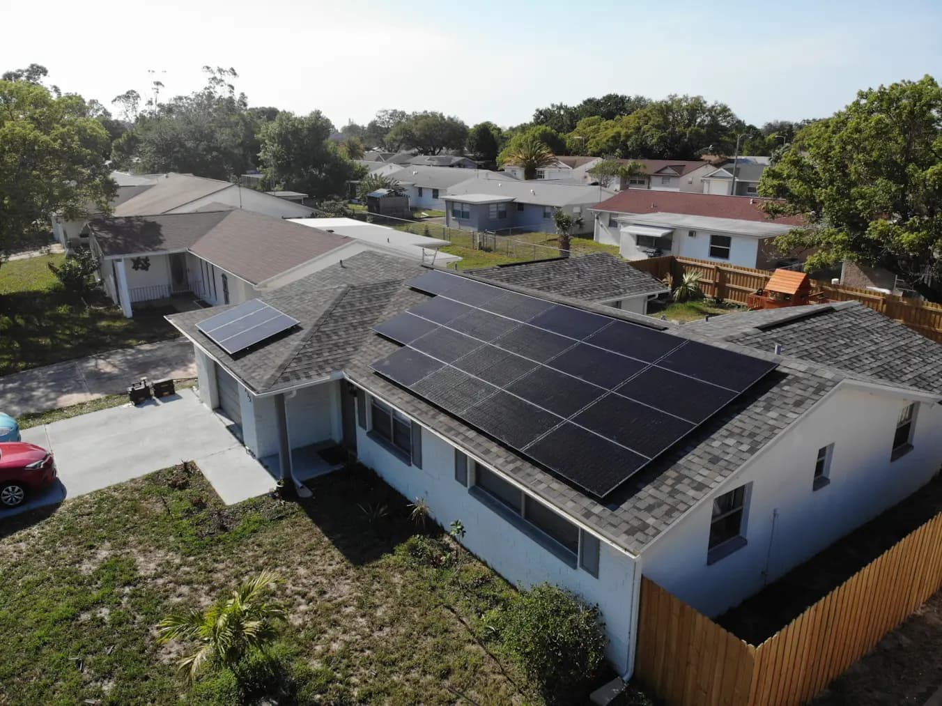 Clean, symmetrical rooftop solar array installed by Lunex on a gray shingle roof.